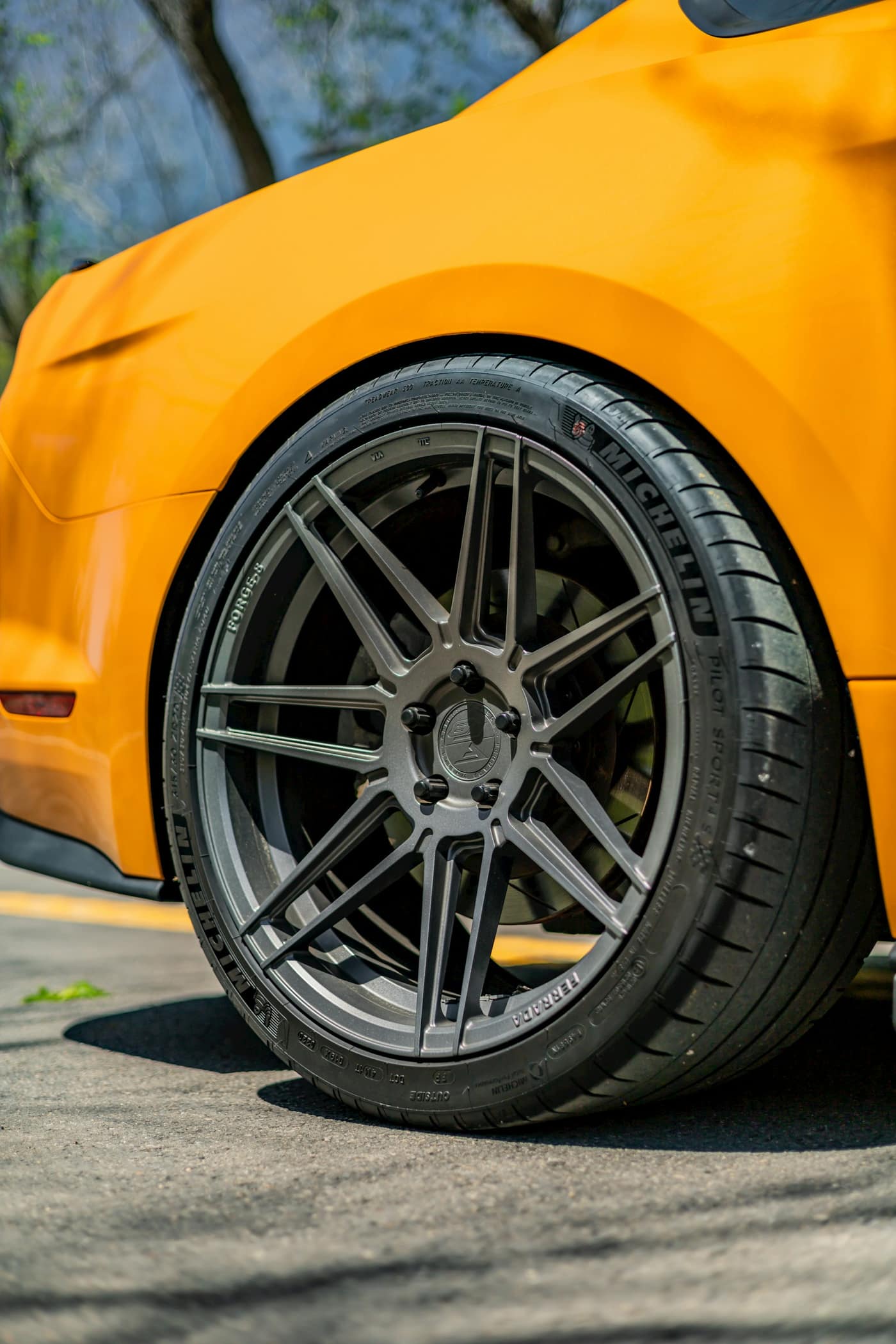 Sports car alloy wheel fitted with a performance tire
